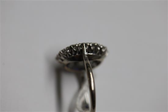A modern white gold?, sapphire and diamond set oval cluster ring, size N.